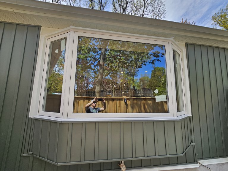 Newly installed modern white bay window in a Barrie home