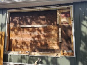 Window opening covered and prepared for replacement (exterior view) 