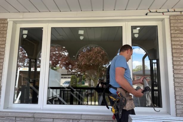Installer sealing and finishing a replacement window during a window installation project in Barrie.
